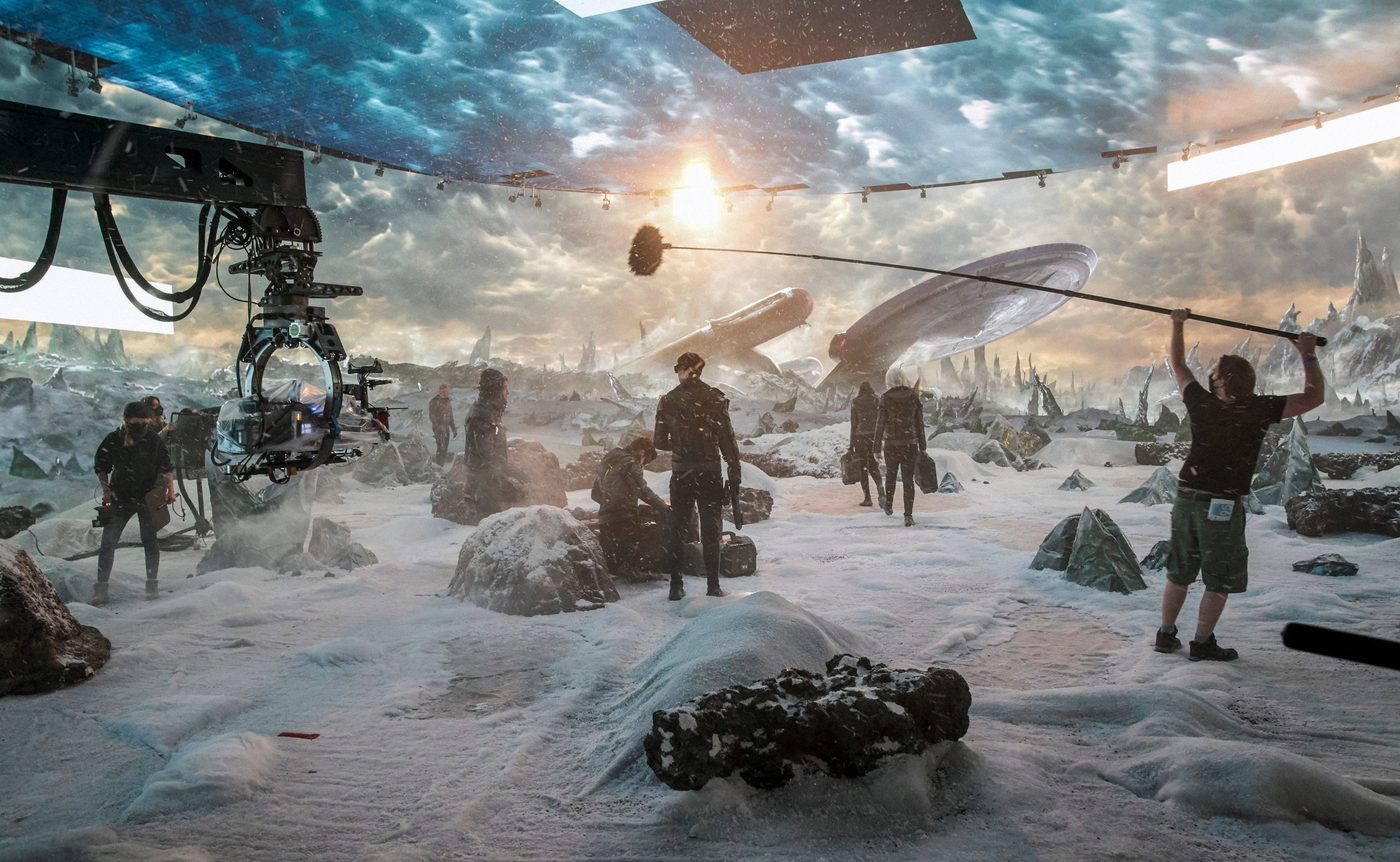 Camera crew and cast shooting an icy alien landscape inside the LED volume on Pixomondo's virtual-production stage in Toronto.